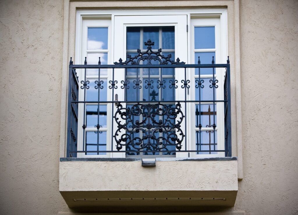 Balcony railing inspired by French design, featuring fleur-de-lis motifs and intricate detailing for a regal appearance