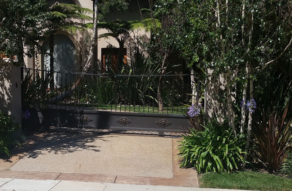 Iron Gate and Landscaping for a Beautiful and Secure Entrance