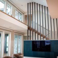 Structural Louver Walls with Floating Stairs